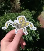 A person holding up a yellow Sticker Giant Prickly Stick Insect sticker.